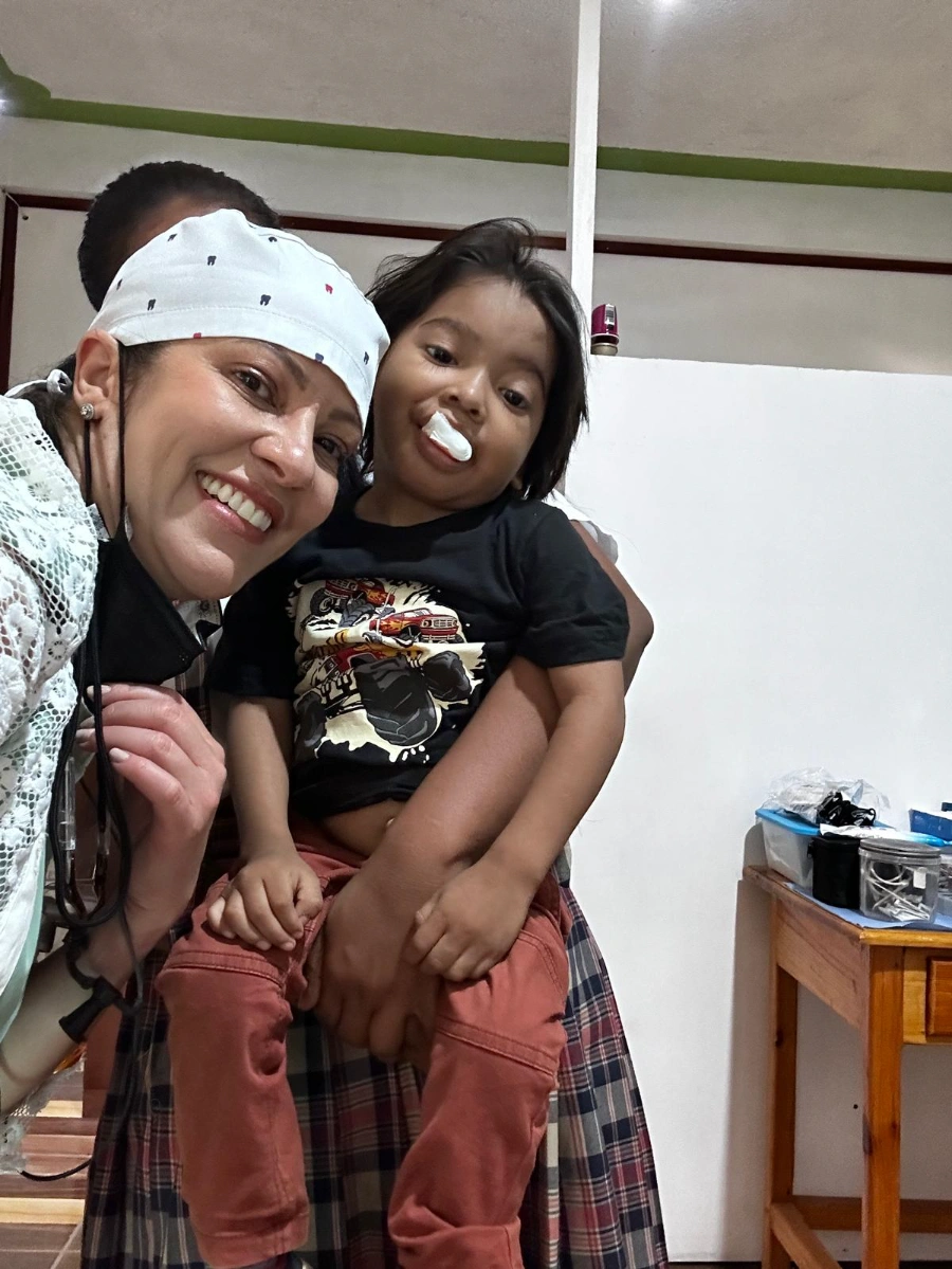 Sylvana Chimenti holding a young patient in Honduras