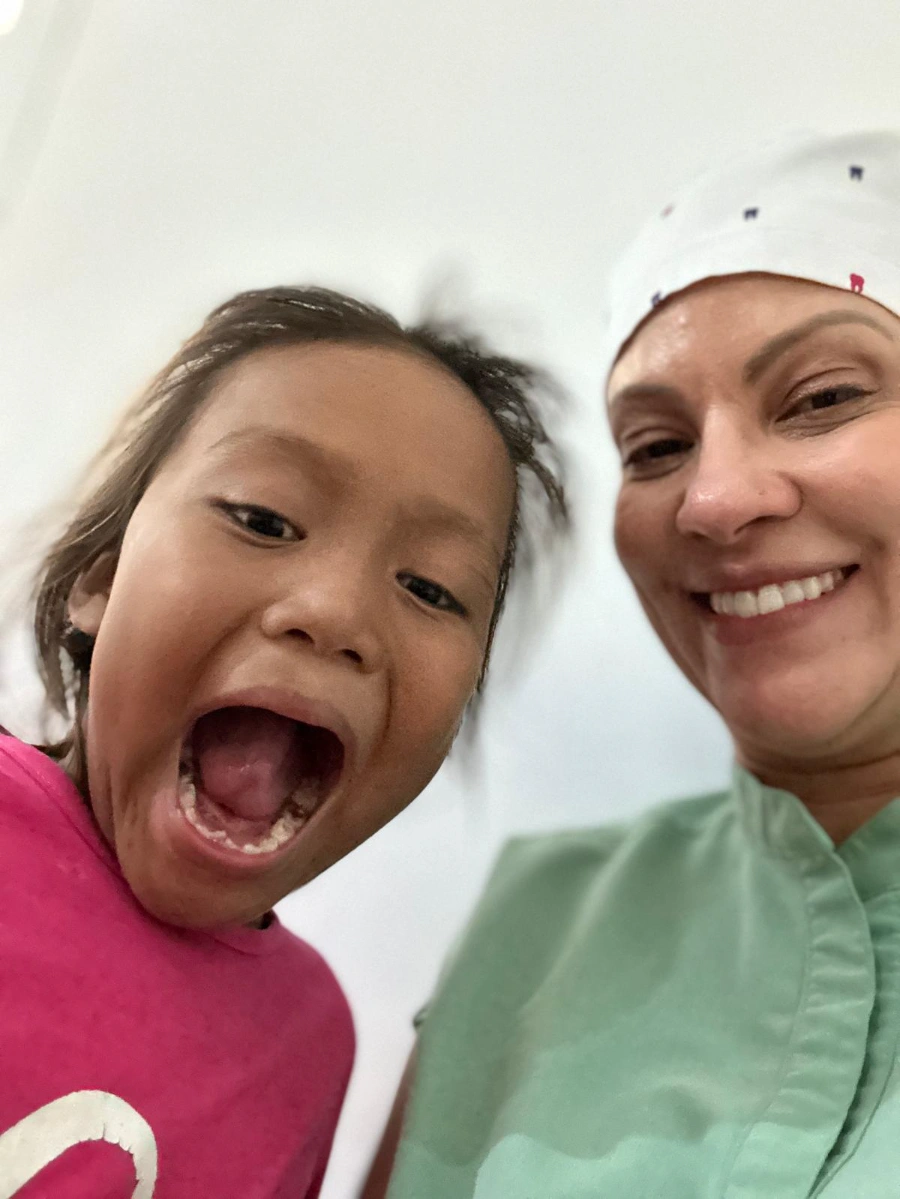 A young patient smiling after treatment in Honduras